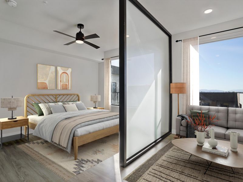 Modern bedroom and living area separated by a frosted glass divider, with natural light and neutral decor at The Hendrey.